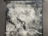a black and white photo of a river running through a forest