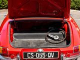 a red car with its trunk open in a parking lot