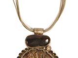 necklace made of metal and wood with a brown bead on a chain