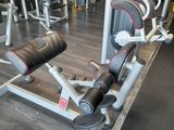 a gym room with a row of machines and weights