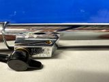 a silver pipe sitting on a counter next to a blue wall