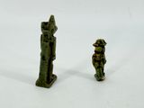 two figurines of a man and a woman standing next to each other