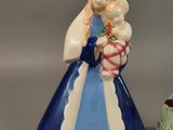 a figurine of a woman holding a baby