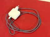 a white power cord attached to a gray power adapter
