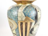 a vase that is sitting on a white surface