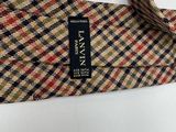a tie with a label on it on a white surface