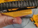 someone is holding a small yellow tool in their hand