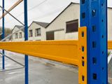 a blue and yellow rack with a yellow bar on it