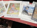 a lot of books on the table with pictures on them