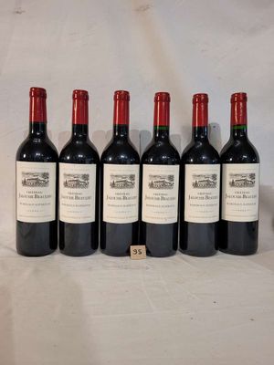 six bottles of wine are lined up on a table