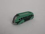 a green toy bus that is sitting on a white surface