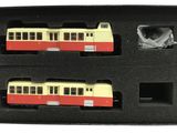 two model trains in a black box on a white background
