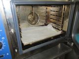 a pan in the oven with a sheet of paper inside of it