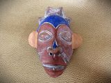 an image of a clay mask on a leather surface