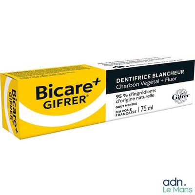 un tube de dentifrice sur lequel est posée une brosse à dents