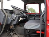 a red truck with a black seat in the back of it