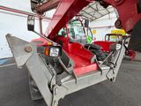 a red crane that is sitting inside of a building