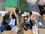 many pairs of shoes in boxes on the ground