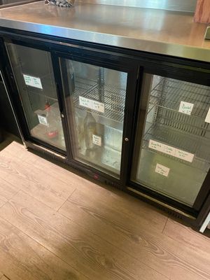 a counter with two glass doors on it in a store