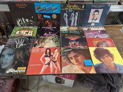a lot of vinyl records on a table in a store