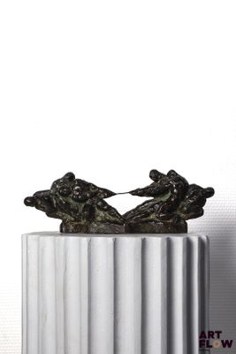a statue of two people on a boat on a pedestal