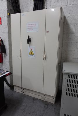 une armoire métallique sur laquelle est accrochée une pancarte, dans une pièce