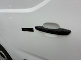 a close up of a car door handle with a sticker on it