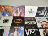 a lot of records on a table with a batman logo on them