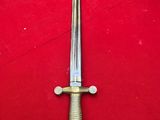 a close up of a sword on a red surface
