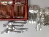 a lot of silverware in a box on a table