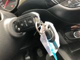 a keychain that is attached to a car ' s steering wheel