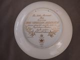 a white plate with a gold and white design on it