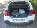 the back of a car with luggage in the trunk of it