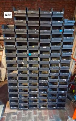 a large stack of crates sitting on a brick floor