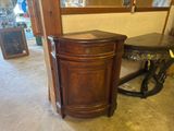 a wooden cabinet with a mirror on the wall