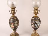 pair of antique lamps with floral designs on them on a white background