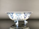 a blue and white bowl sitting on top of a table