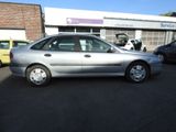 a silver car that is parked in a parking lot