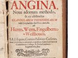 an old book with writing on it sitting open on a white surface