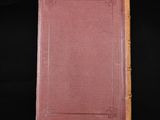 an old book on a black surface with a black background