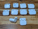 a lot of white electrical plugs sitting on a wooden table