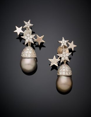 a pair of pearl and diamond earrings