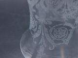 a clear glass with a pattern on it on a table