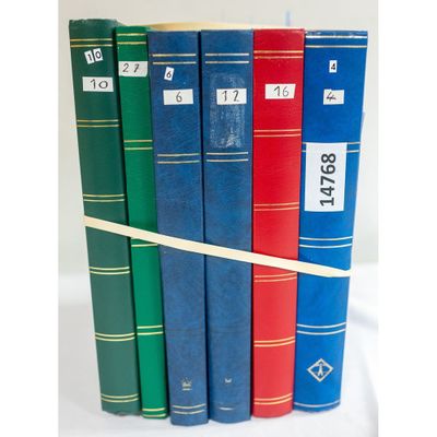 several books are stacked on top of each other on a white surface