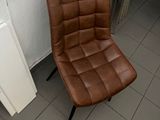 a brown chair sitting in a bathroom next to a radiator