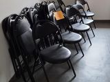 des rangées de chaises noires dans une pièce avec une fenêtre à l'arrière-plan