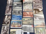 an assortment of old postcards and postcards on a table