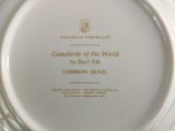 a white plate with gold writing on it on a table