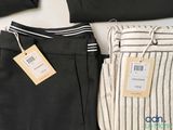 two pairs of pants with a price tag on them sitting on a table