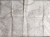 an open book with a map on top of it sitting on a table